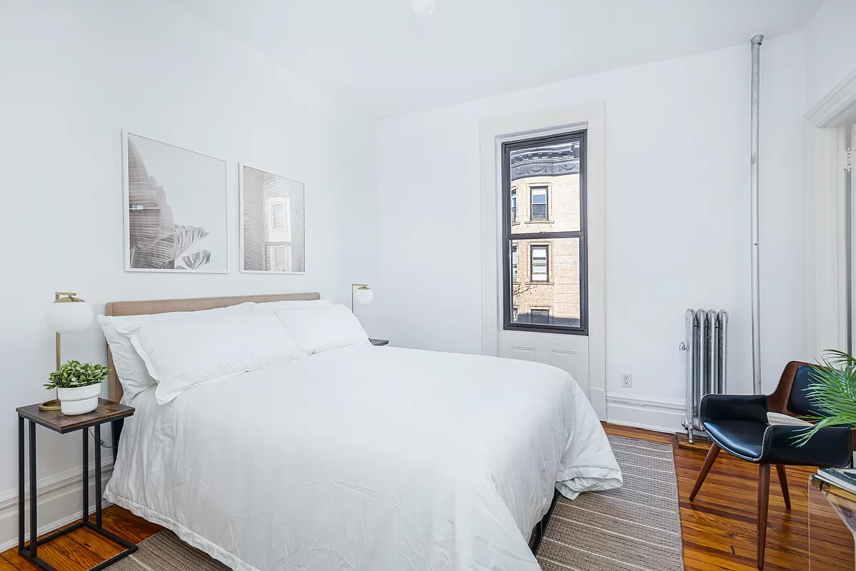 bedroom with wood floor and one window