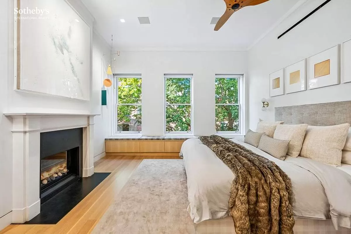 bedroom with mantel and a window seat