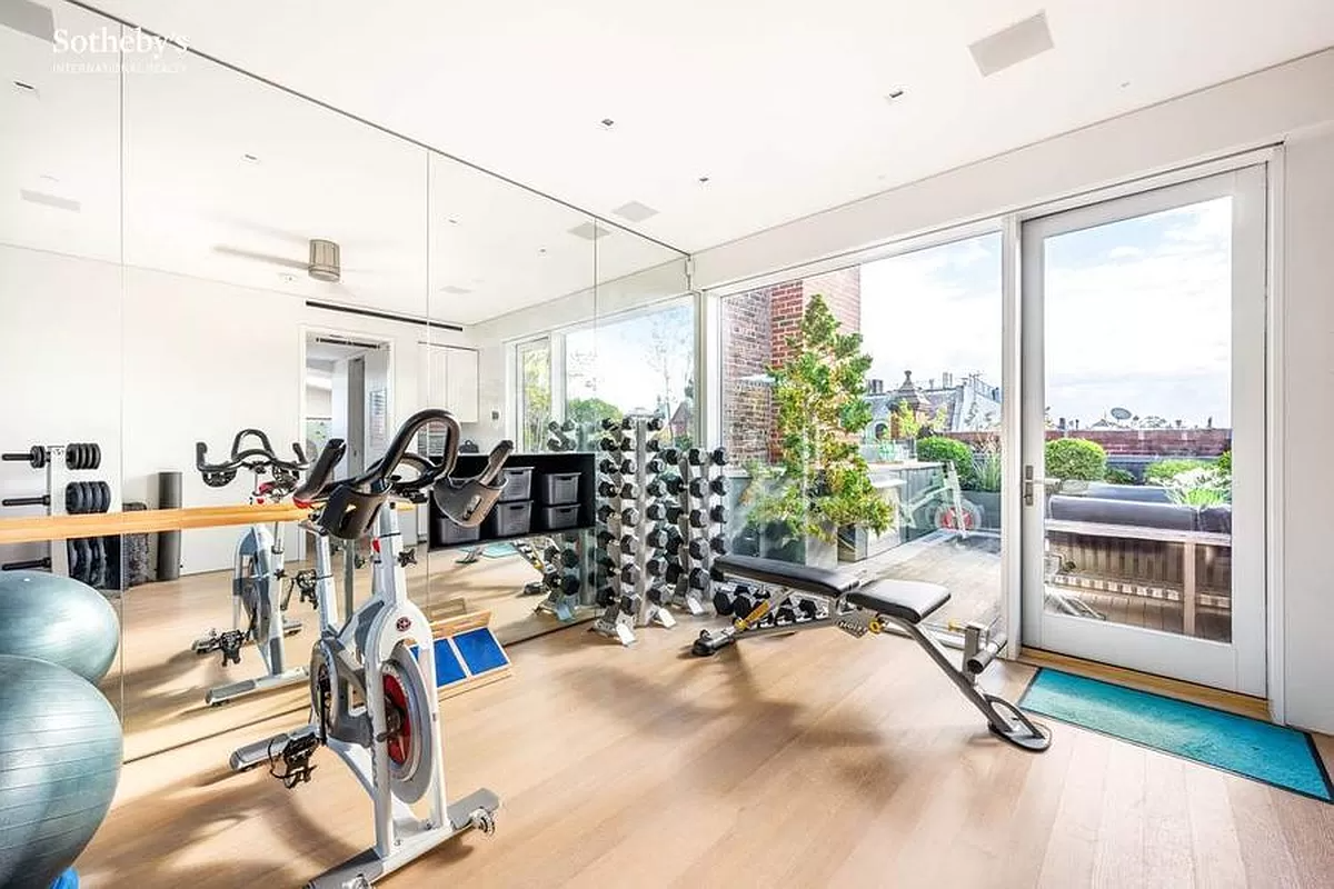 gym with mirrored wall and door to terrace