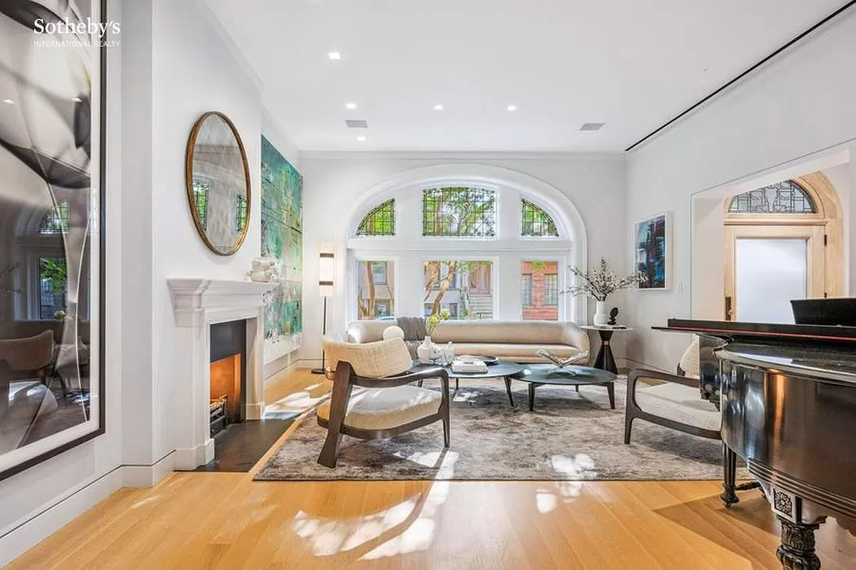 parlor with mantel and arched window