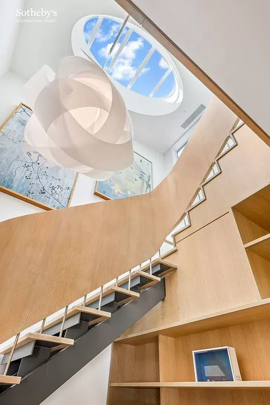 look up to the skylight brining light to the modern wood stair