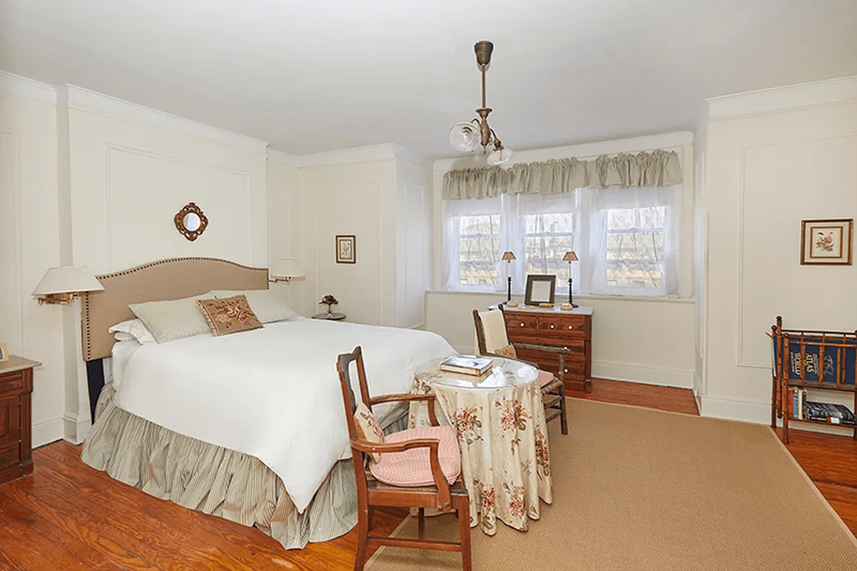 bedroom with wall moldings and picture rails