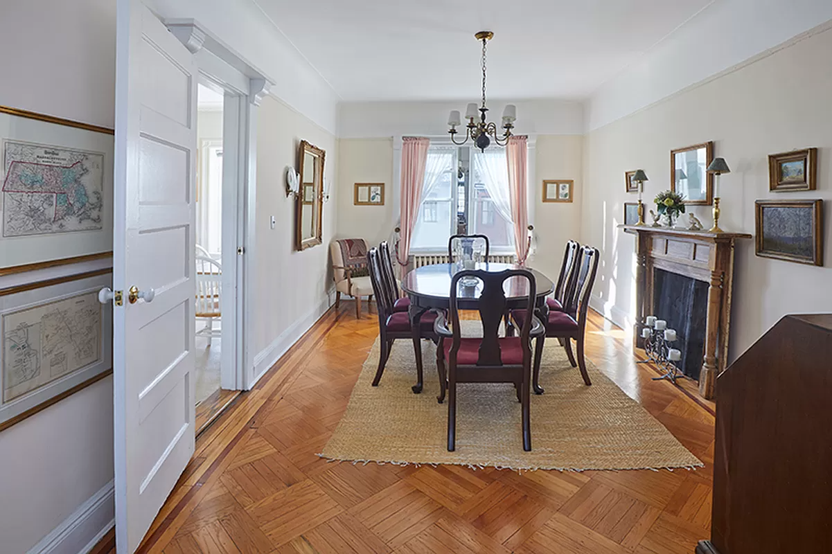 dining room with picture rails, mantel and wood floor