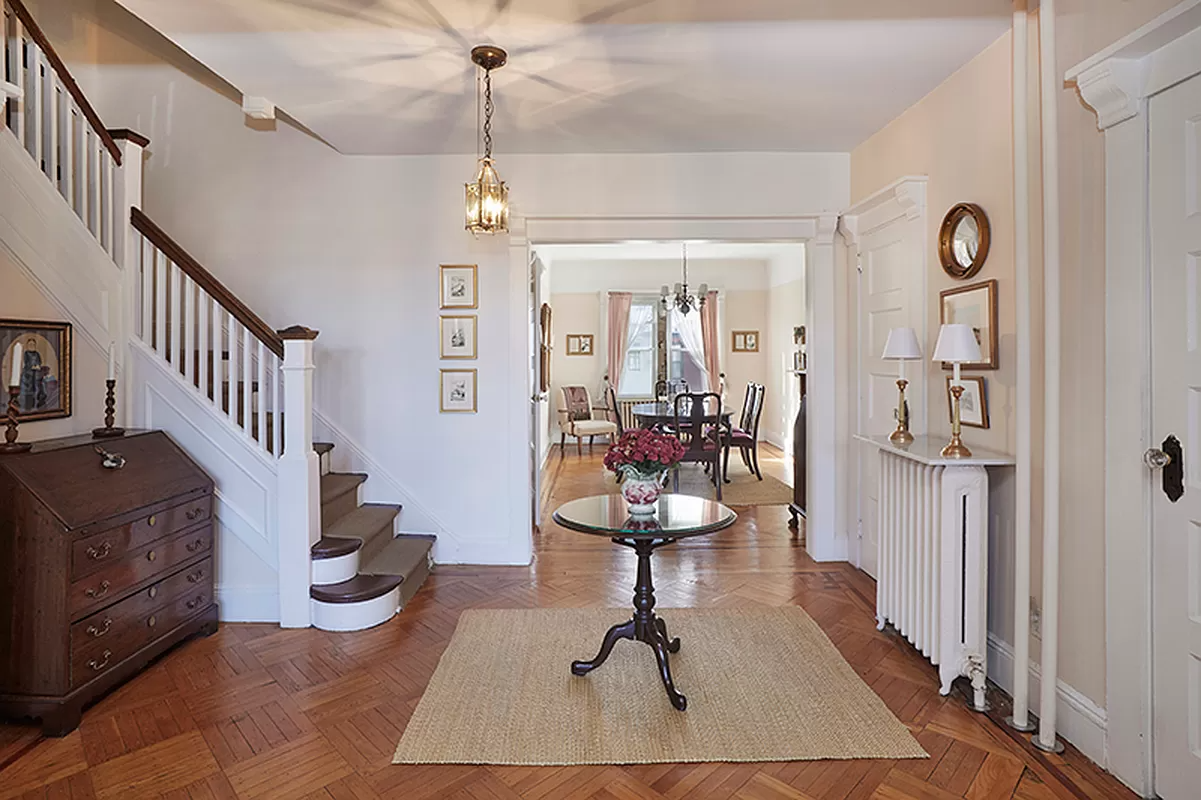 entry with wood floor and view into dining room