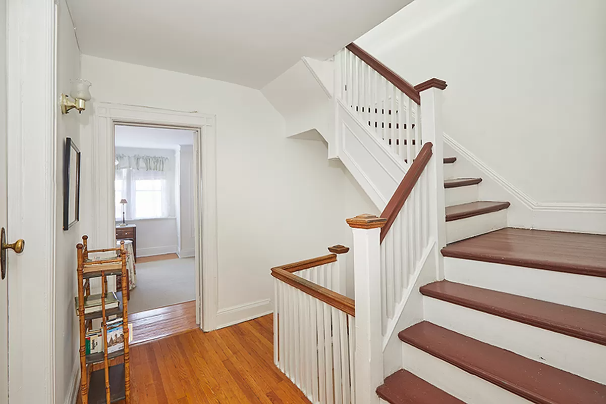 upstairs hall with original stair with white painted railing