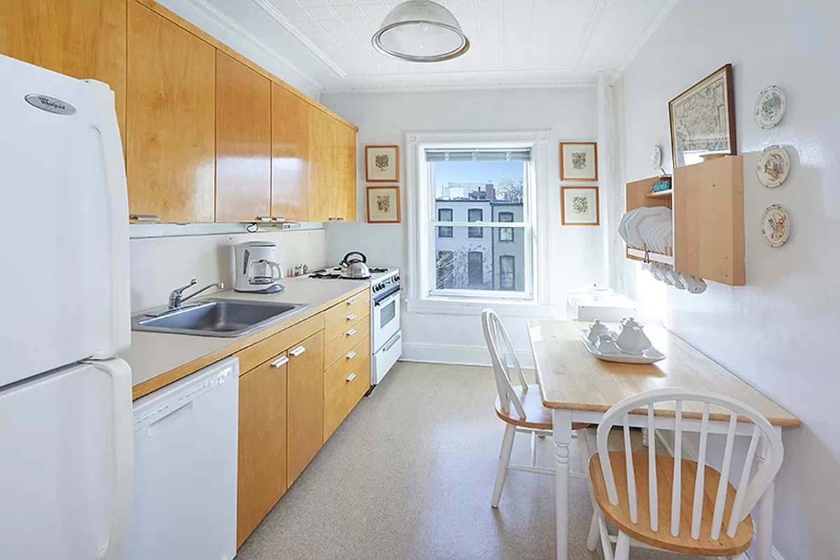 kitchen with wood cabinets and white appliances