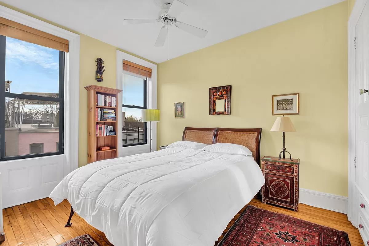 bedroom with two windows and a ceiling fan