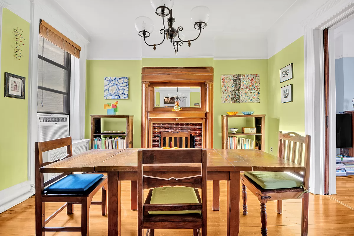 dining room with pocket doors to living room and a columned mantel