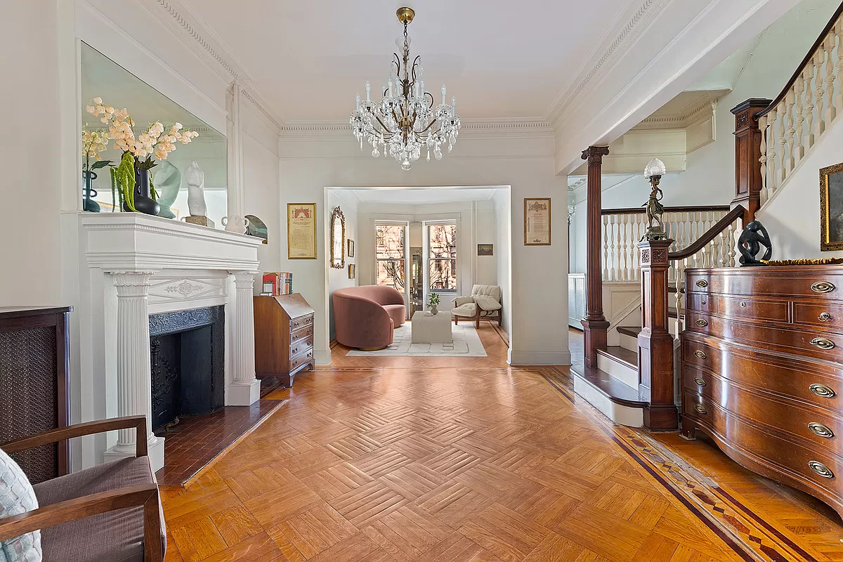 brooklyn - middle parlor with white mantel, wood floor and an original staircase