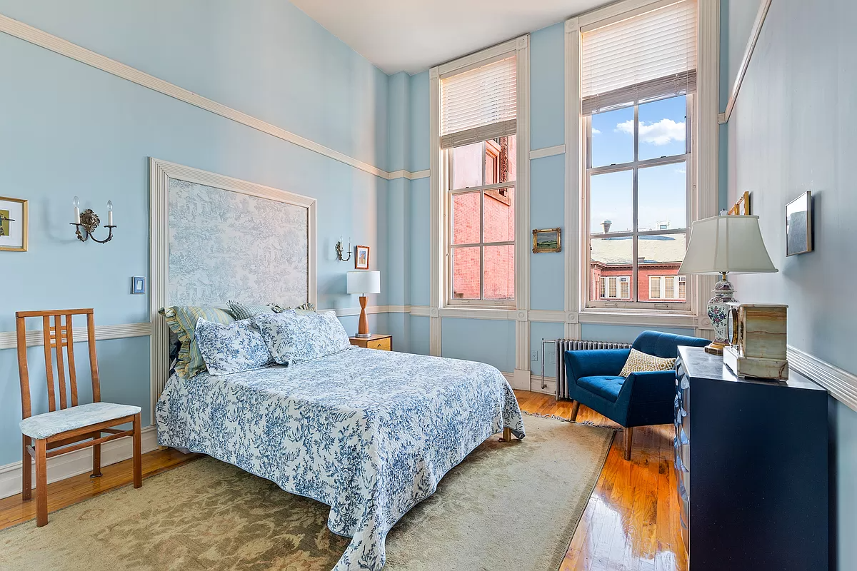 bedroom with two windows and wood floor