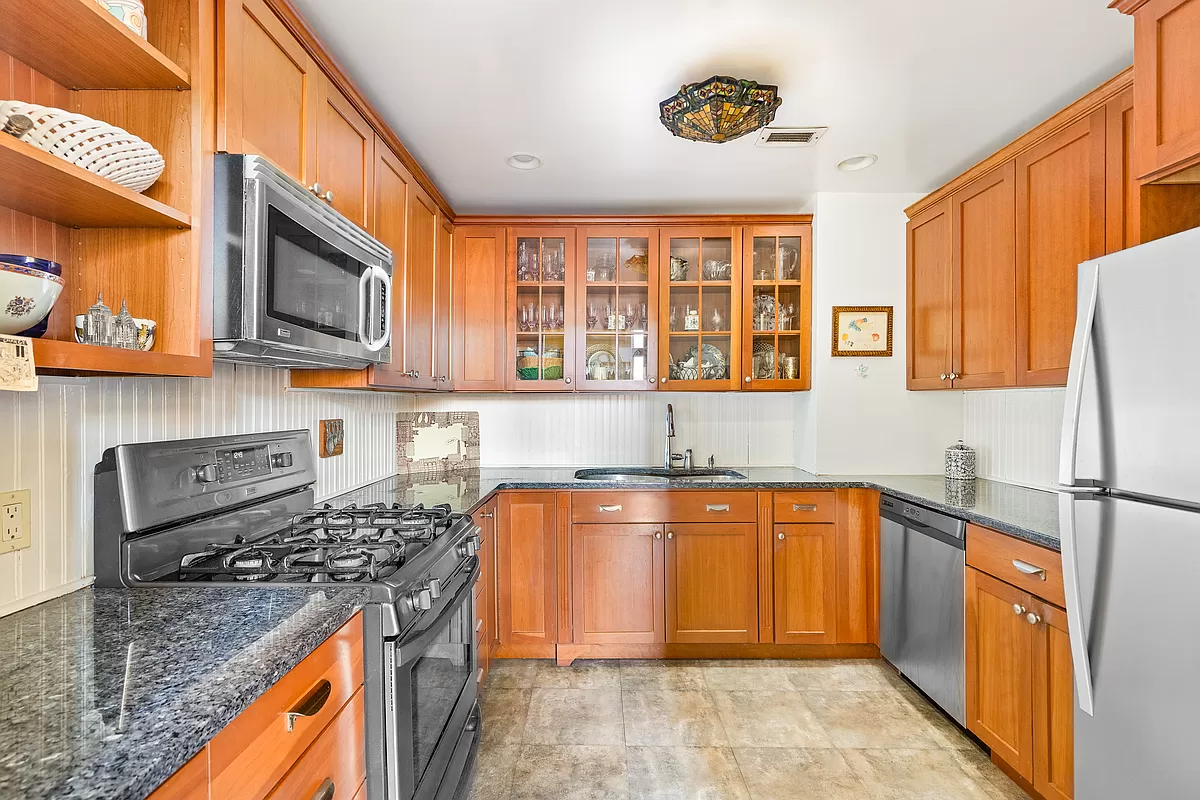 kitchen with wood cabinets and beadboard on the walls