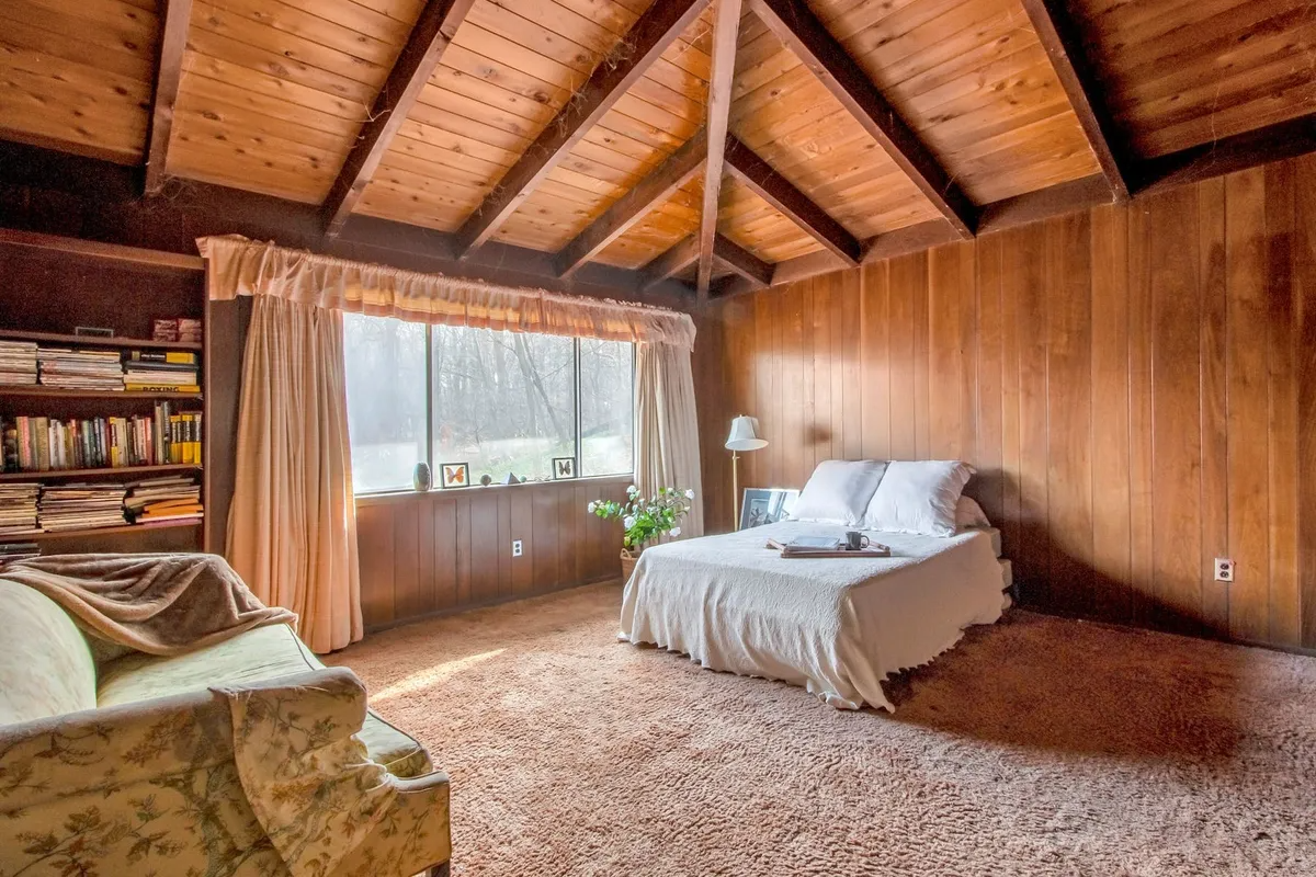 bedroom with carpet and wood ceiling and walls