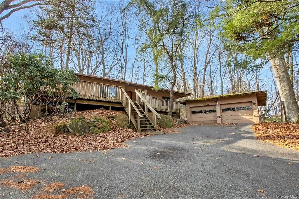 exterior showing driveway and garage adjacent to house