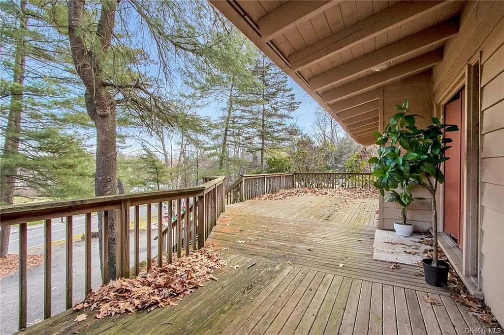 deck with view of front door reached via stairs