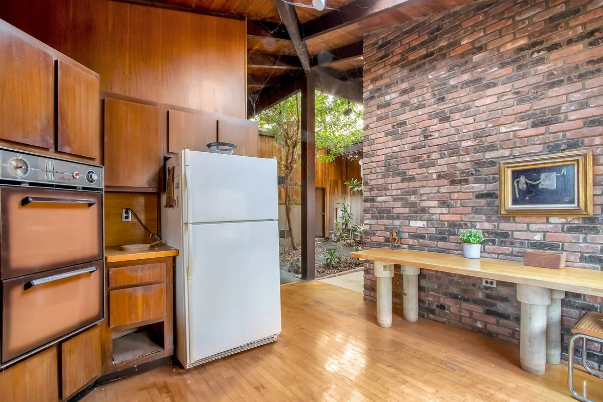 kitchen with original double ovens and alter white fridge