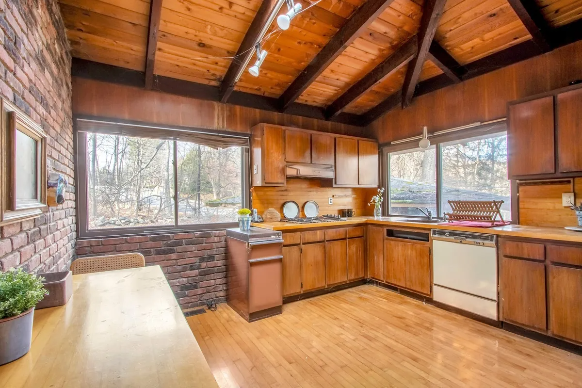 kitchen with some brick and some wood walls