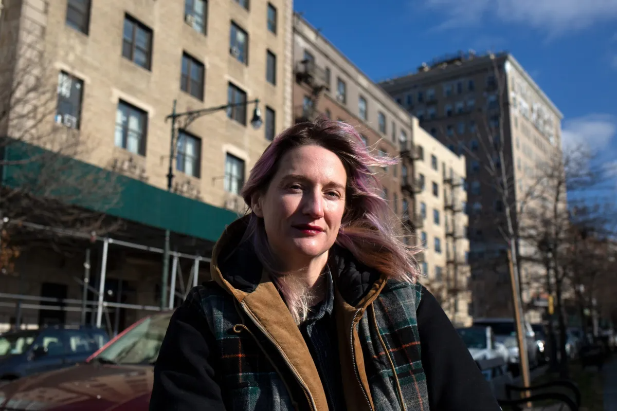 "Clare Sherry poses for a portrait on Eastern Parkway across from the Brooklyn Public Library