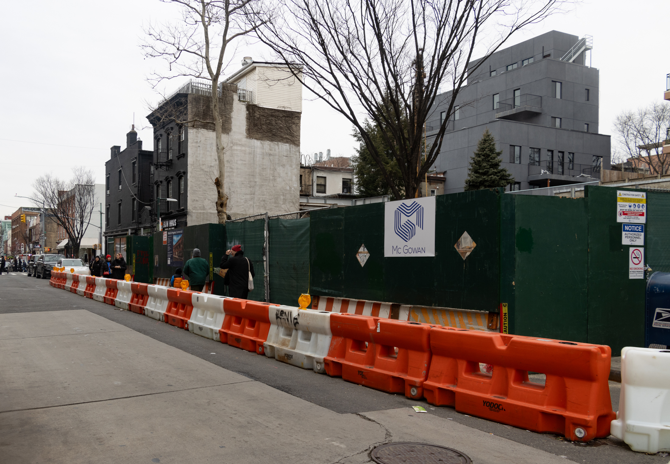 people walking by the construction site