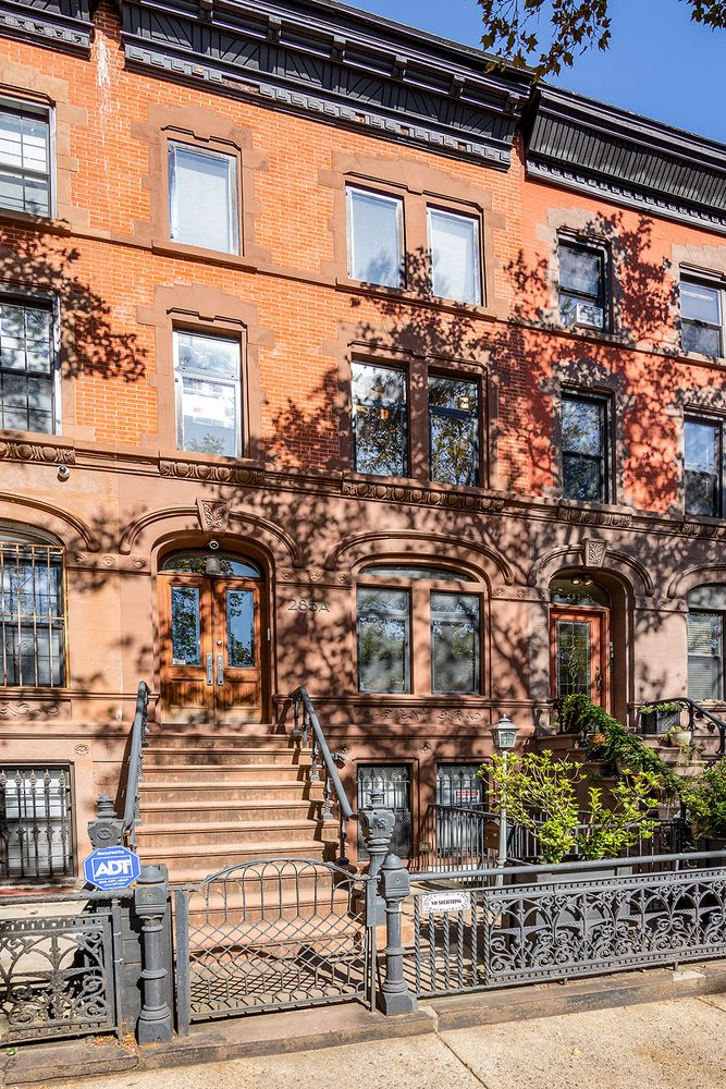 brownstone and red brick exterior of the row house
