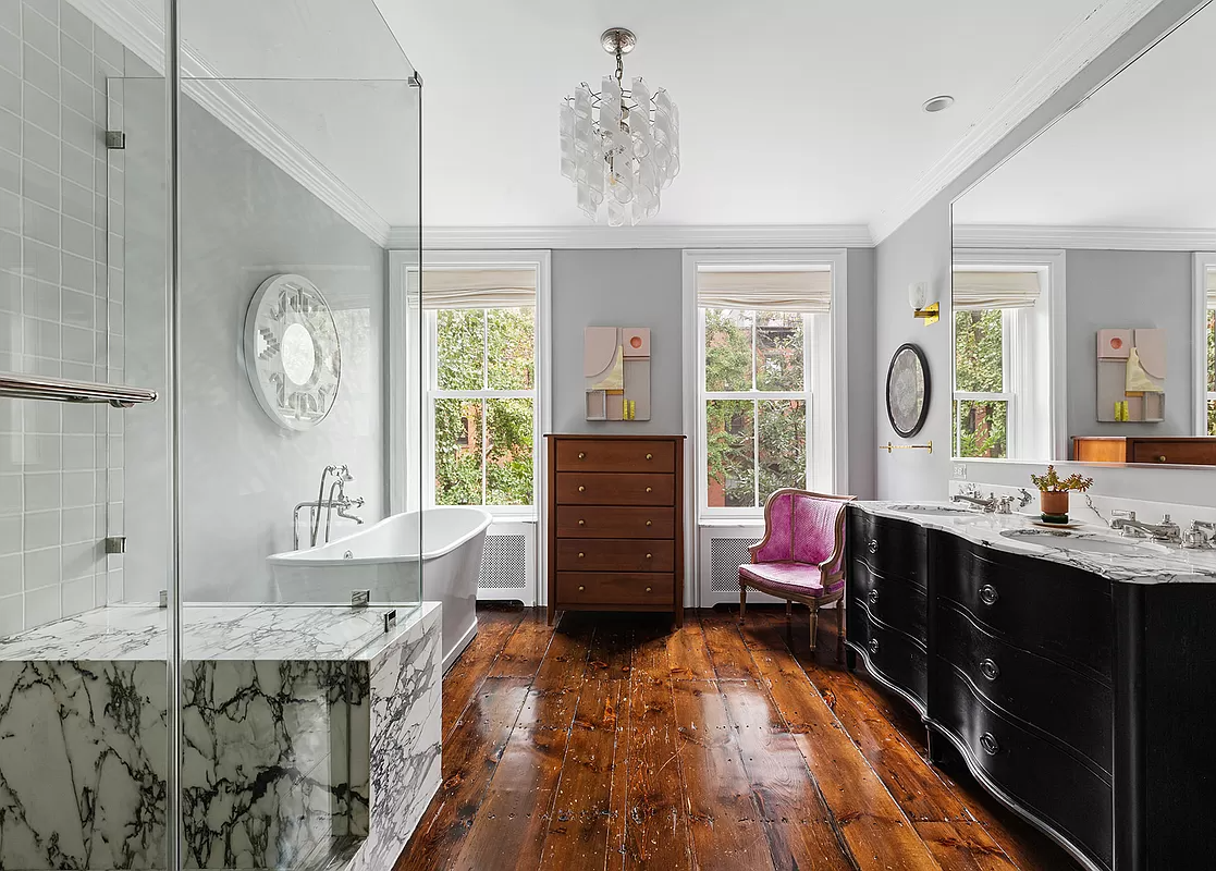 bathroom with wood floor, glass shower, and a soaking tub