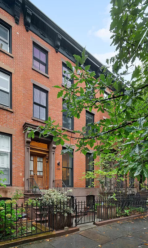 front facade with red brick and brownstone lintels and door surround