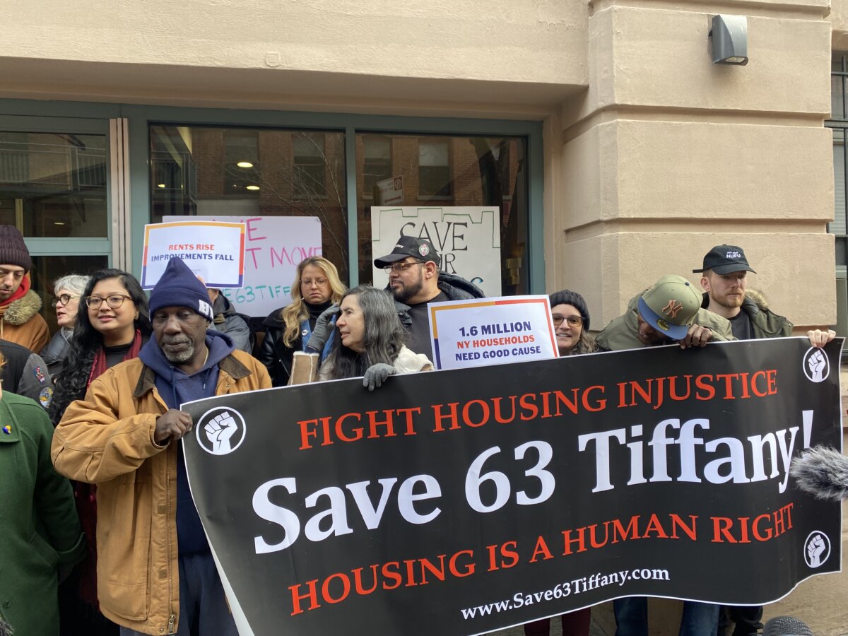 tenants - residents holding a banner and protest signs