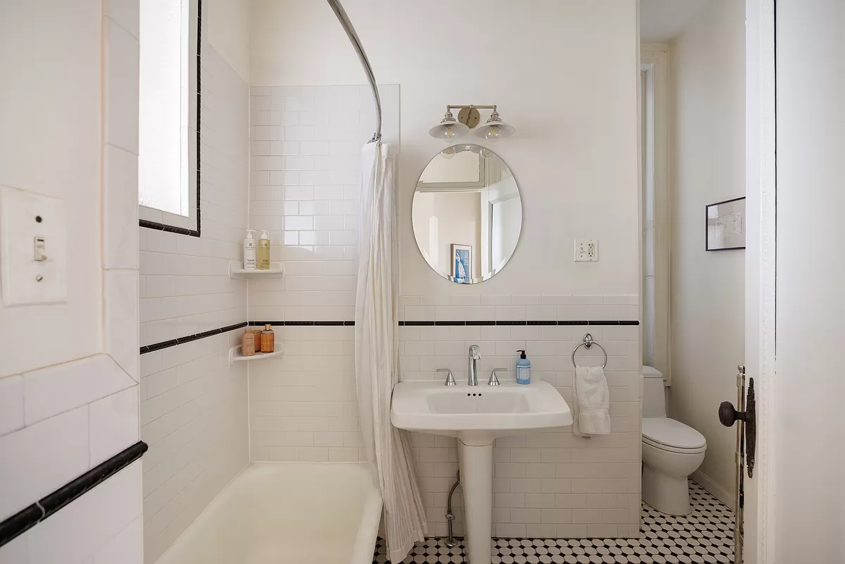 bathroom with black and white tiles