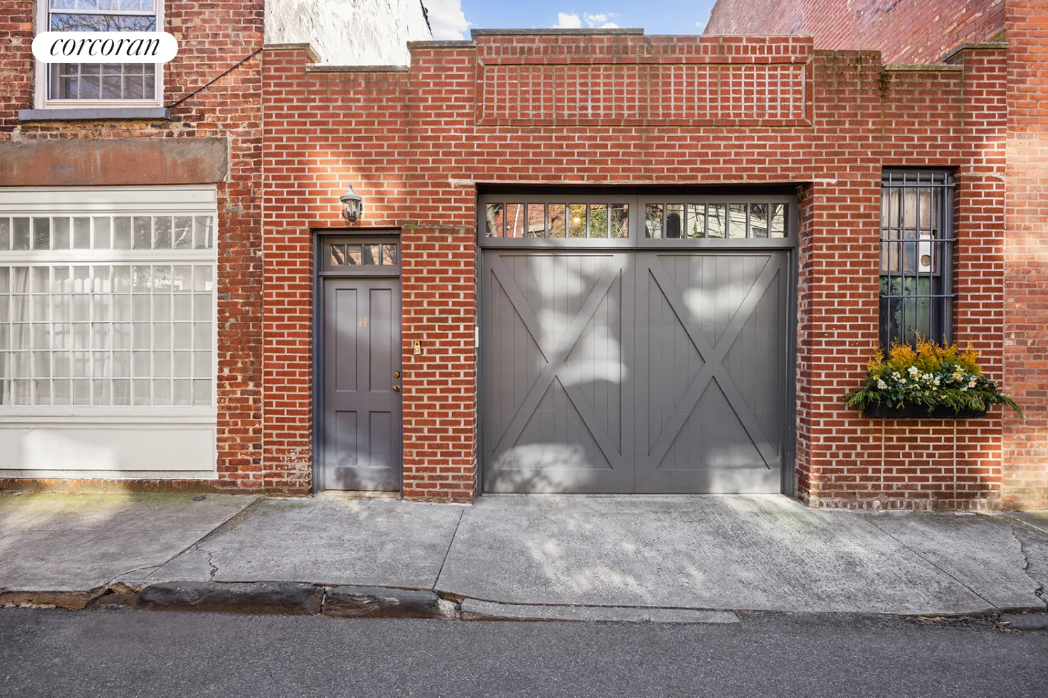 brick carriage house with gray doors