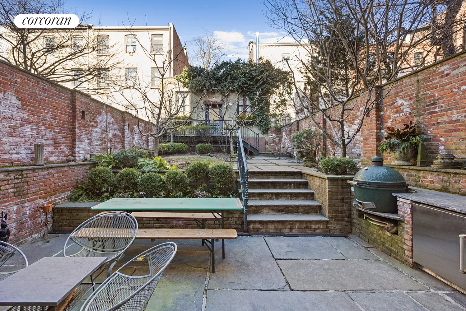 landscaped rear yard with stone patio and access to carriage house