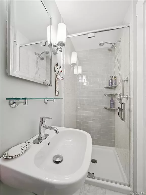 bathroom with a glass door to a walk-in shower