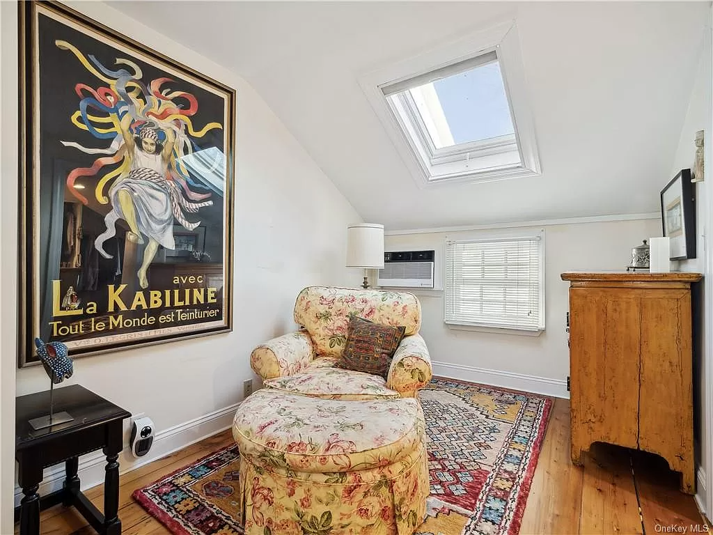 bedroom with skylight and small window