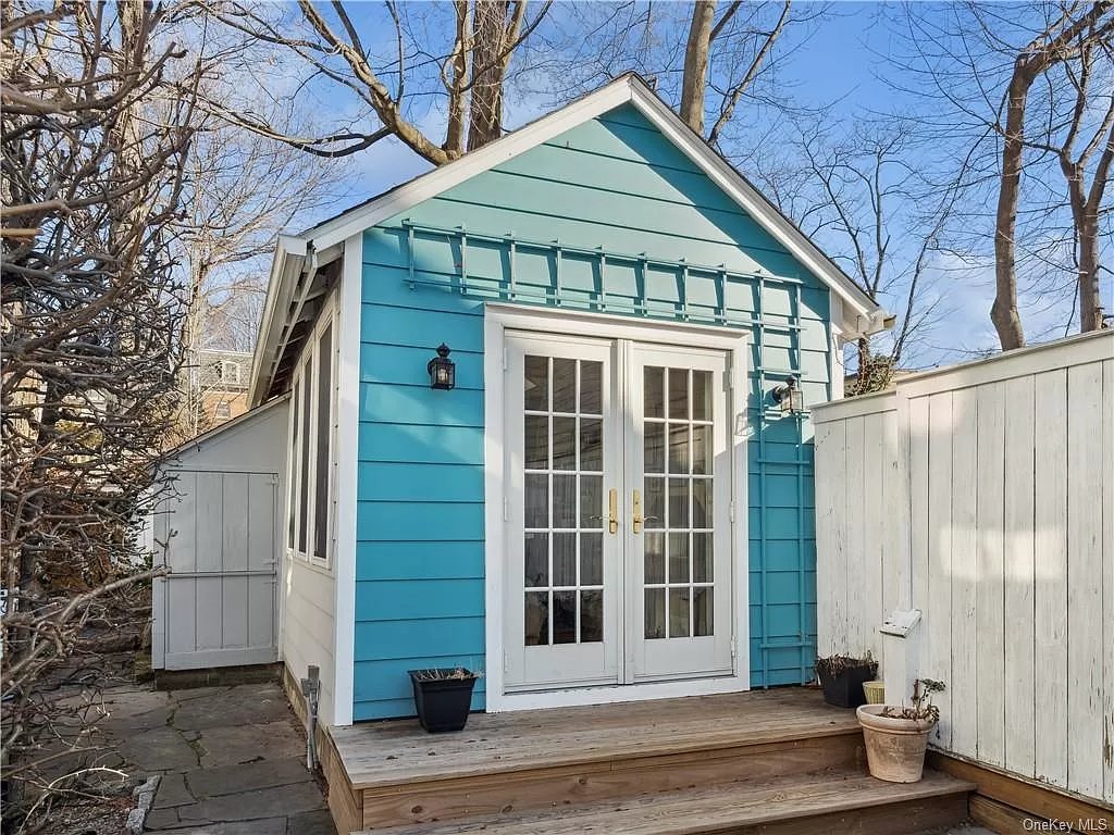 bright blue rear lot house with french doors