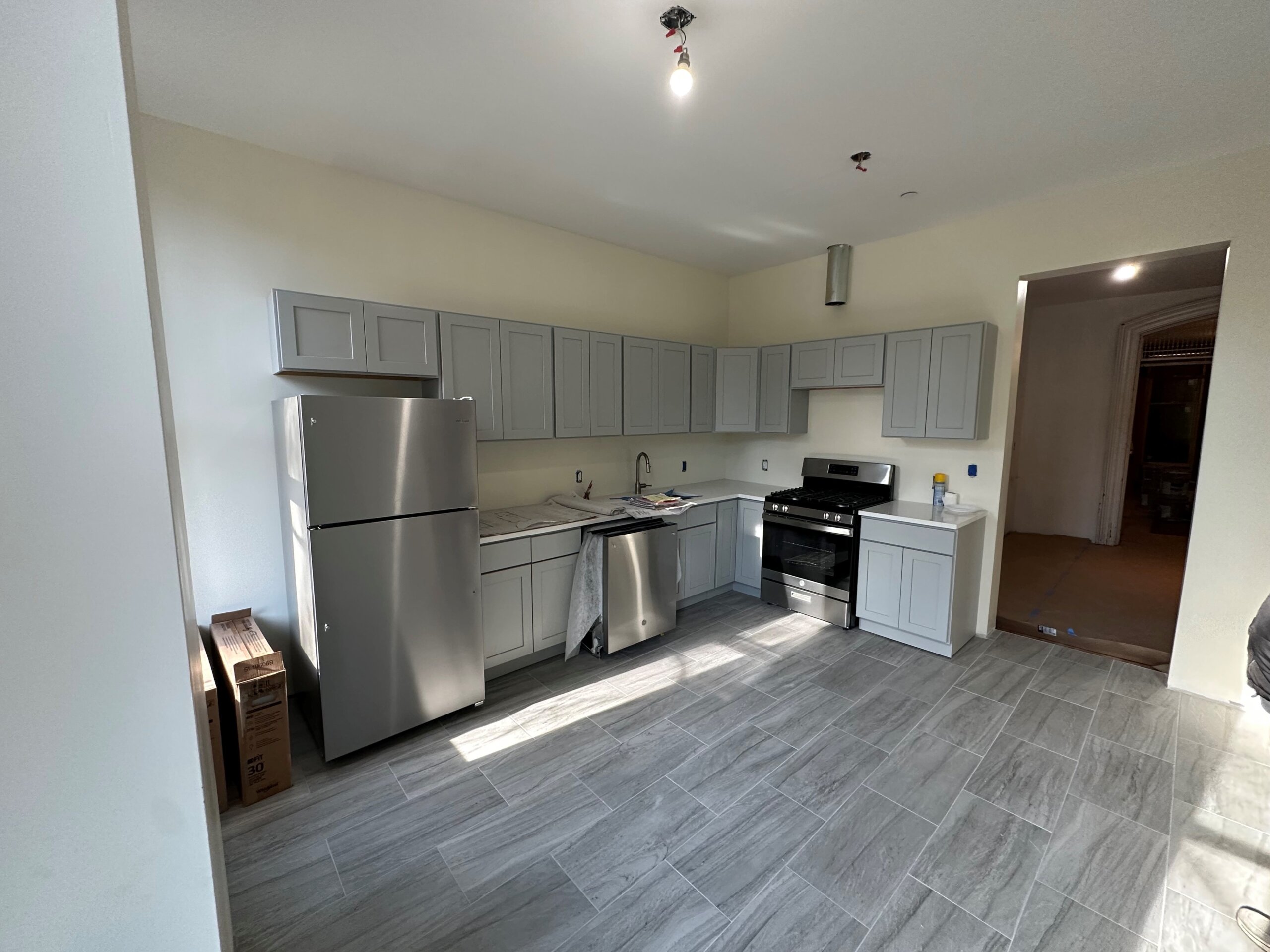 kitchen with gray cabinets and stainless steel appliances