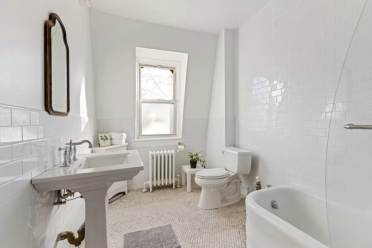 bathroom with white fixtures and white subway tiles