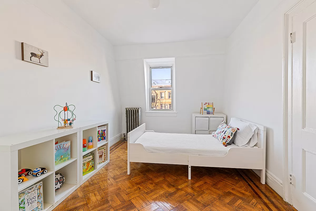 bedroom one window and wood floor