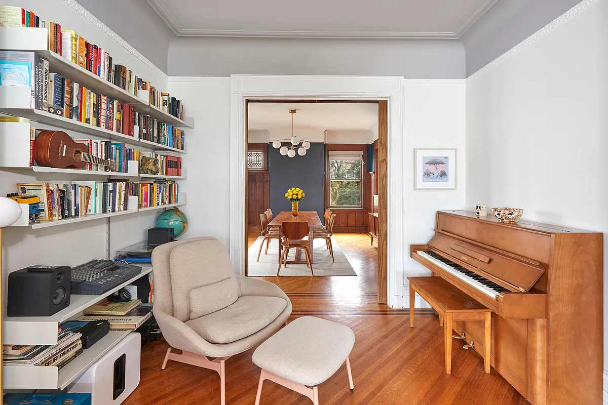 parlor with picture rail and wood floor