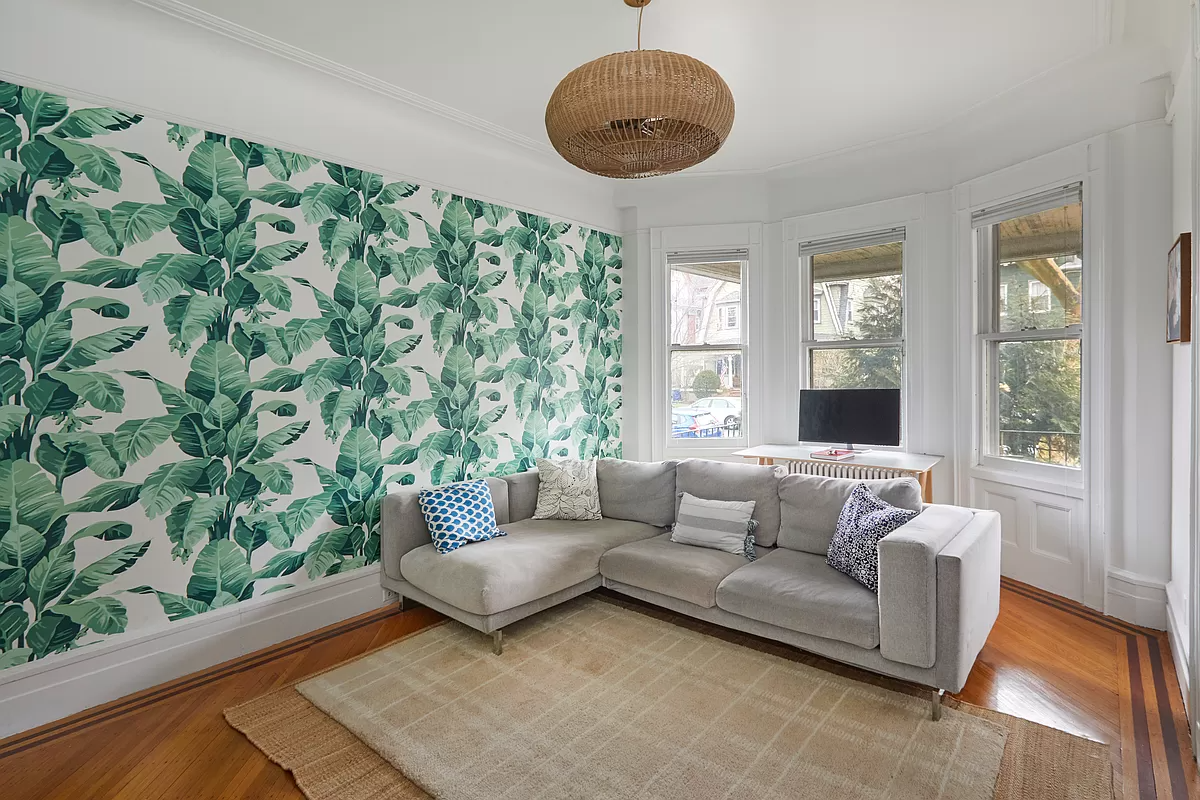 parlor with palm wallpaper on one wall