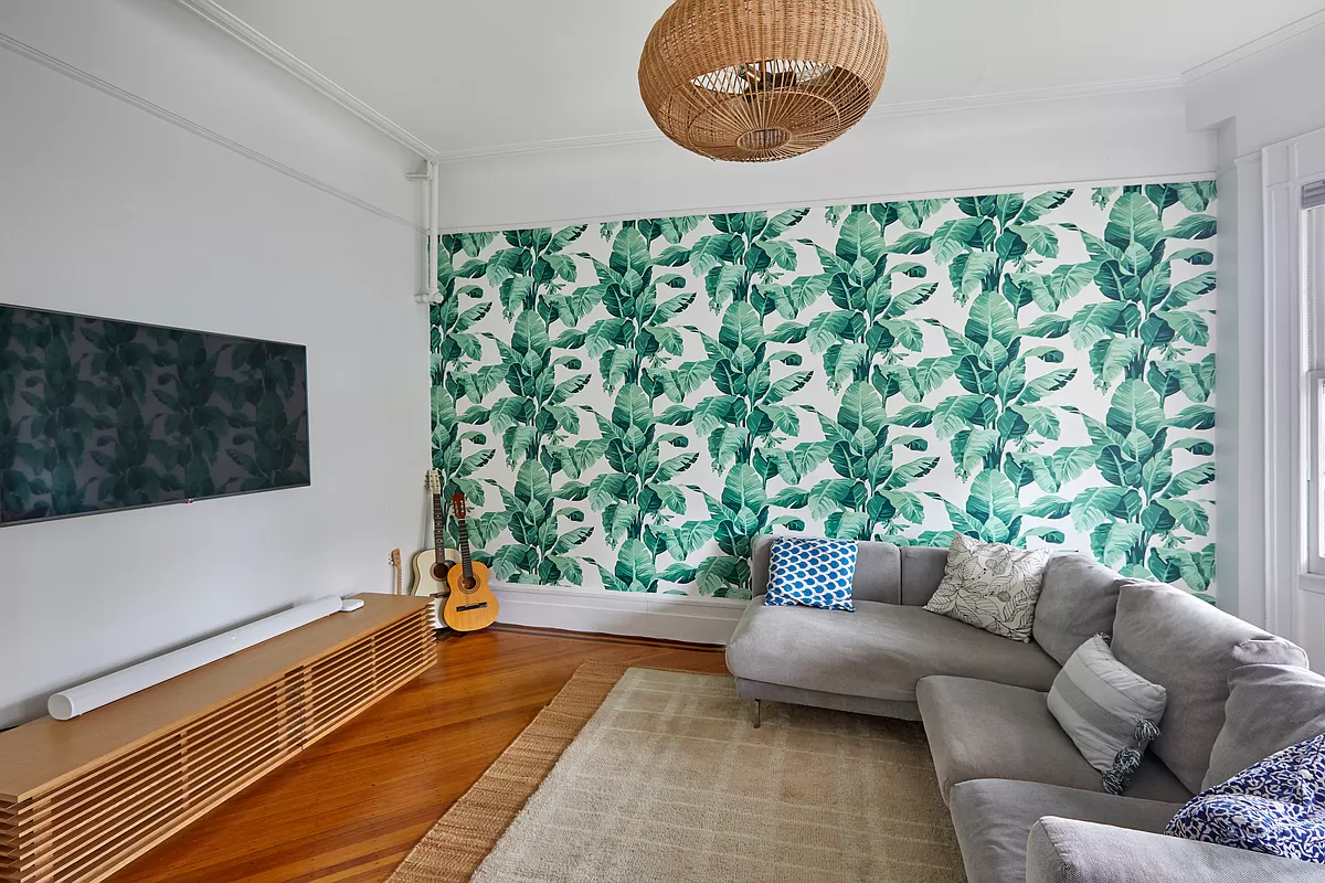 parlor with palm wallpaper on one wall