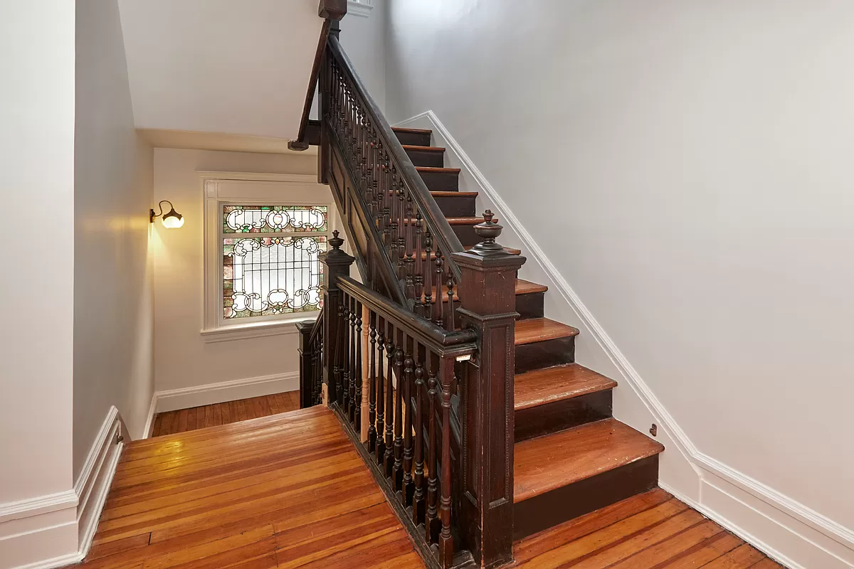 staircase with view of stained glass window