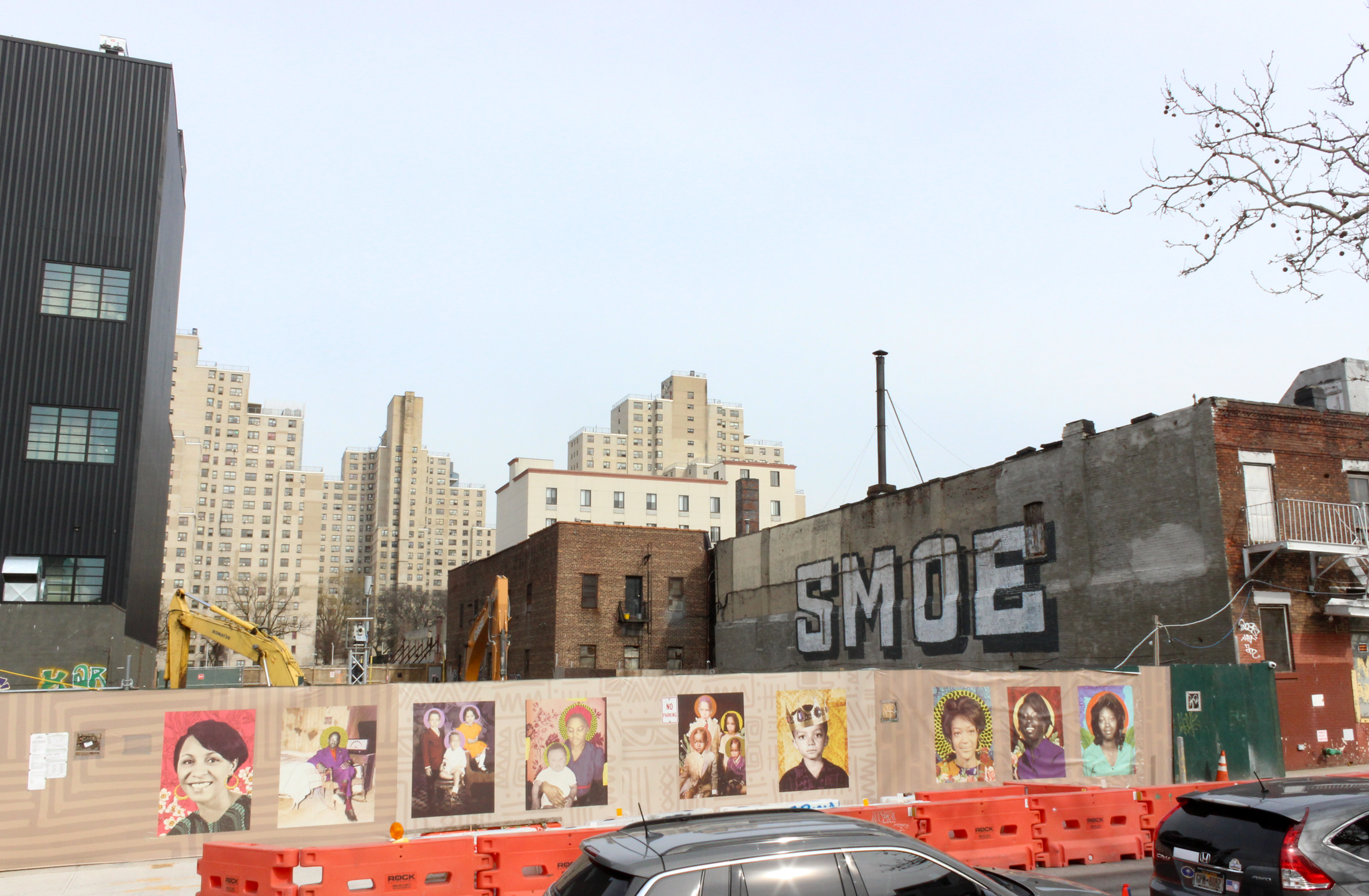 construction fence decorated with posters