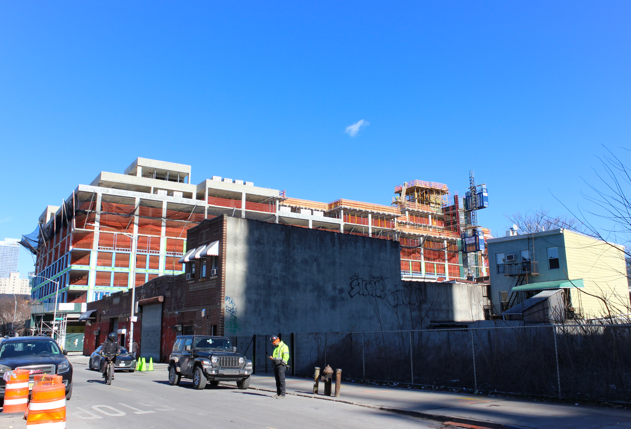 new building under construction with older buildings in the foreground