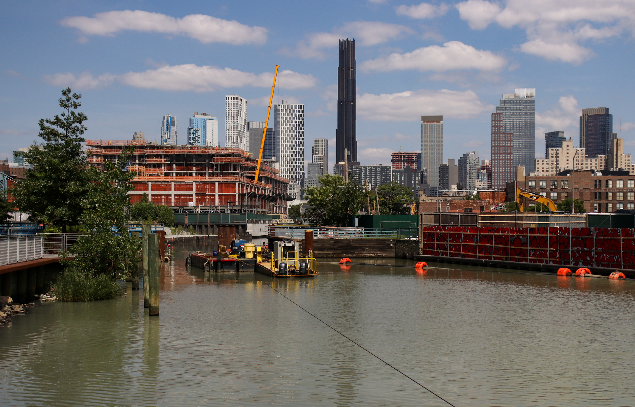 view along the canal with downtown brooklyn skyline in the background