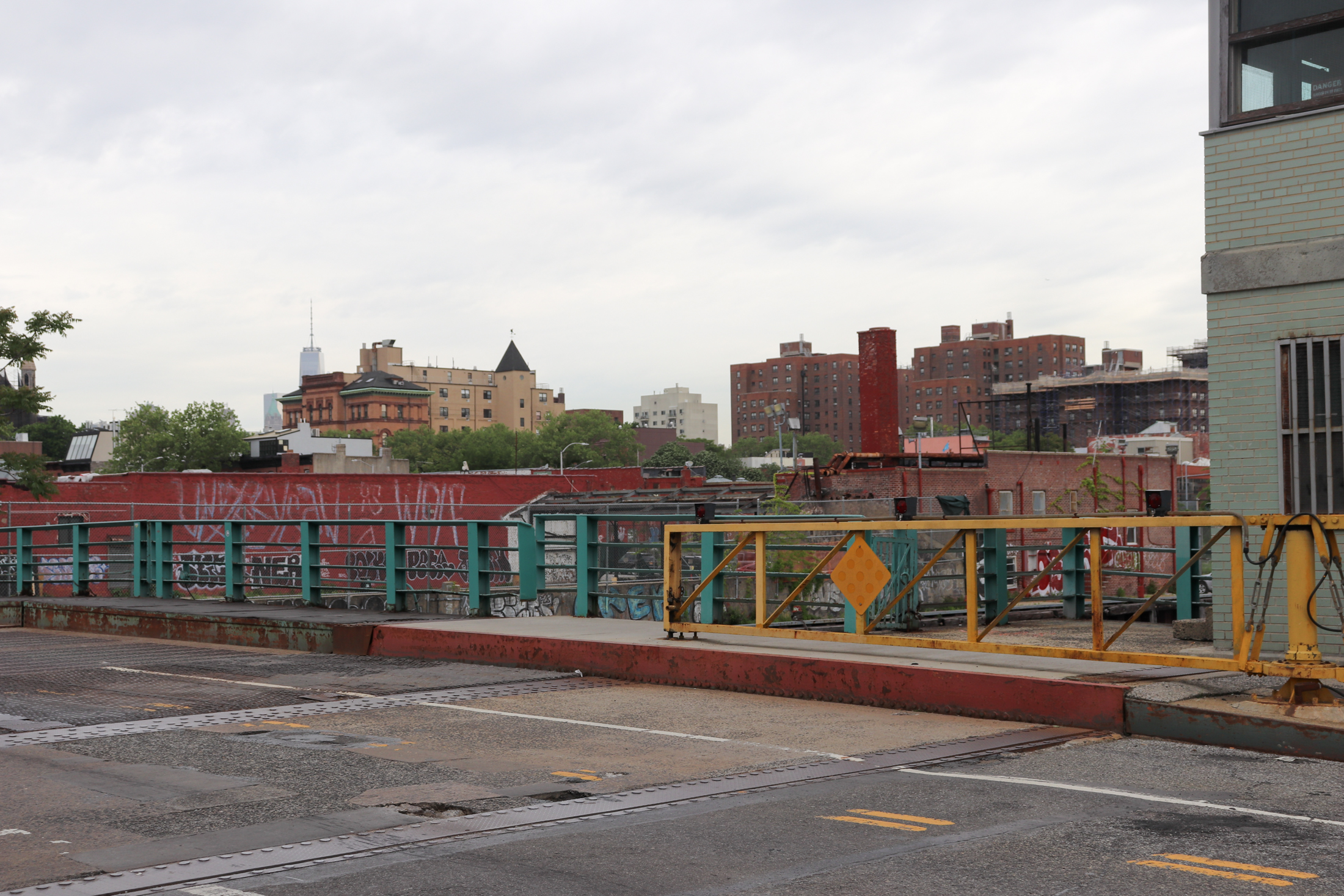 bridge rails with low scale buildings along the canal