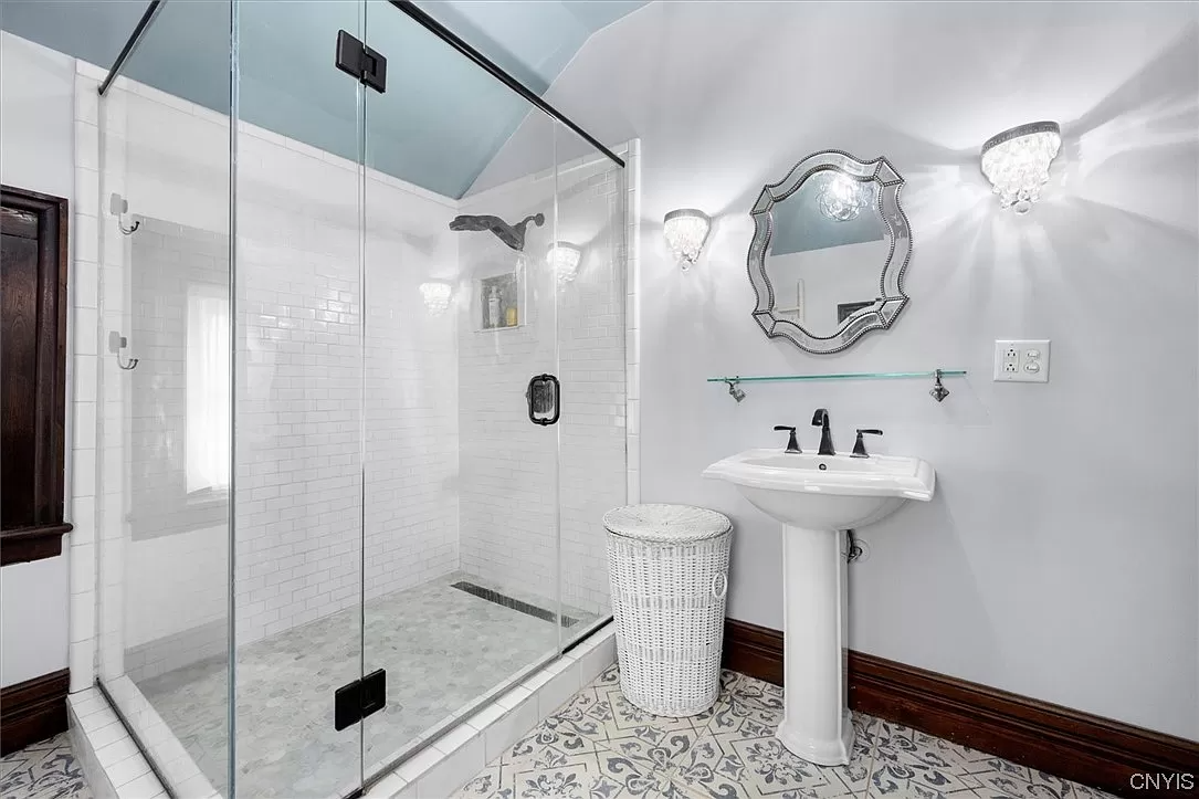 bedroom with glass shower and white sink