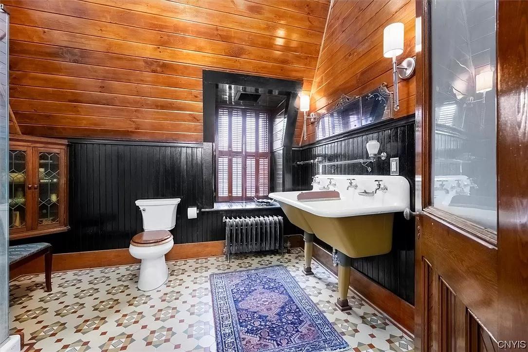 bathoom with wood walls and wainscoting