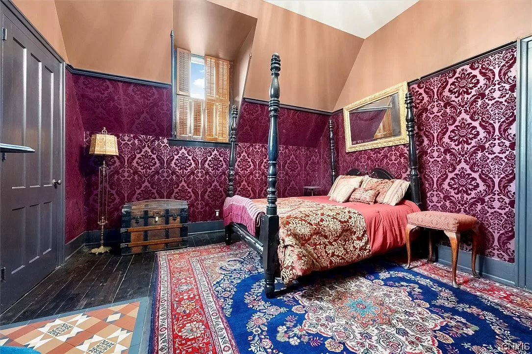 bedroom with damask wallpaper and painted floor