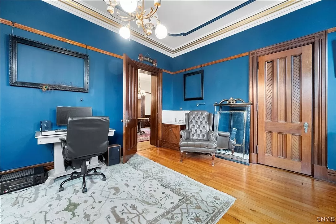 bedroom with wood floors and blue painted walls