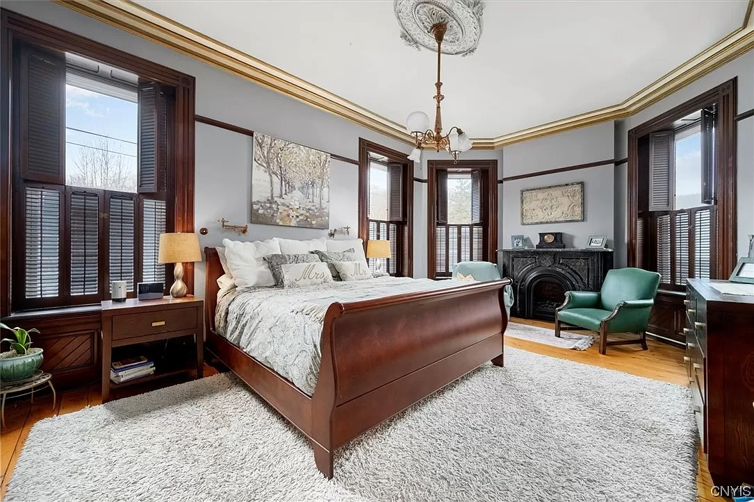 bedroom with three exposures and a black mantel