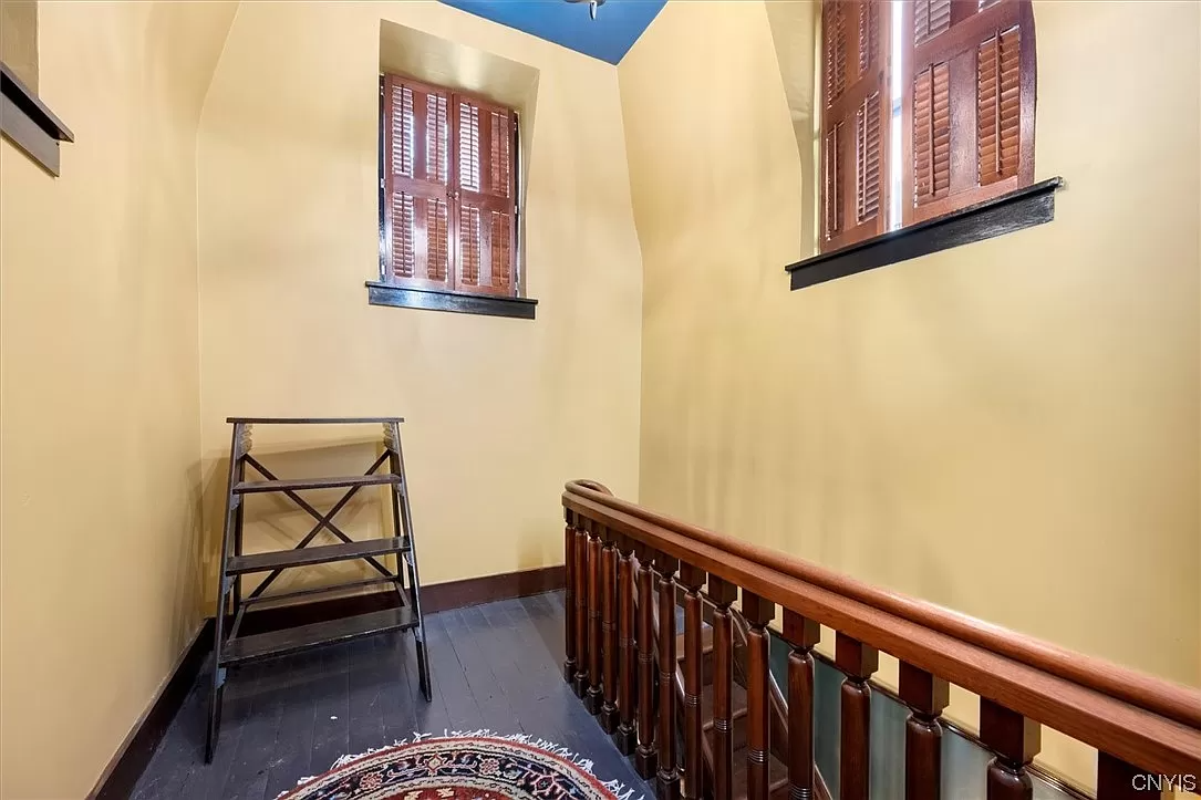 room at top of the cupola with shuttered windows and a painted floor