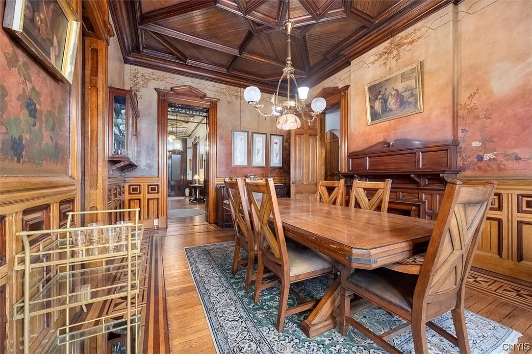 dining room with wood ceiling, wainscoting and hand painted walls